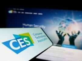 Smartphone with logo of trade organization Consumer Technology Association (CTA) on screen with website.